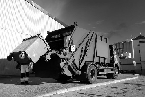 Skips and vans parked on a Barbican street for waste collection